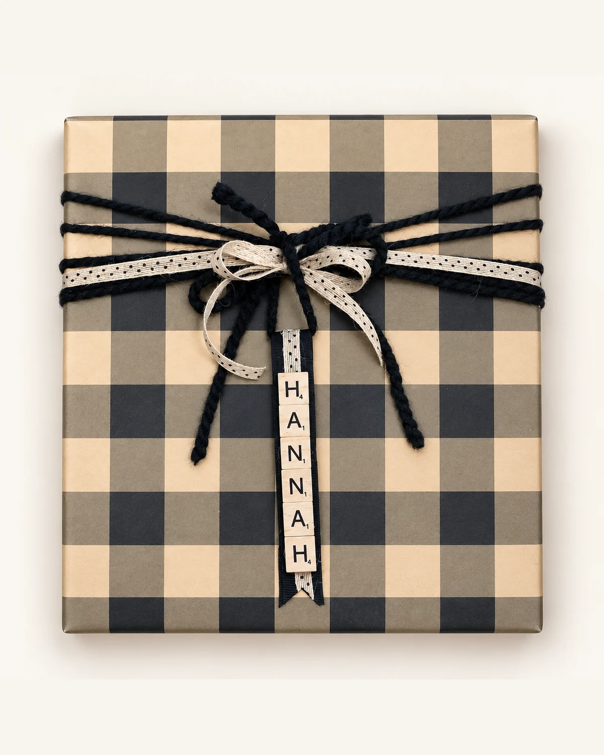 Buffalo check gift with black yarn, burlap ribbon and a Scrabble-tile name tag reading Hannah
