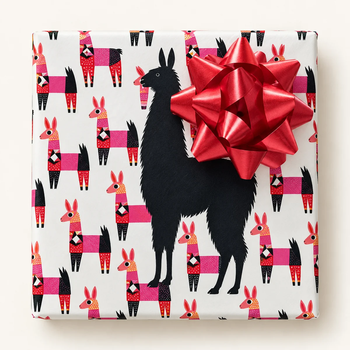 White llama-print paper with a black llama silhouette and a big red bow