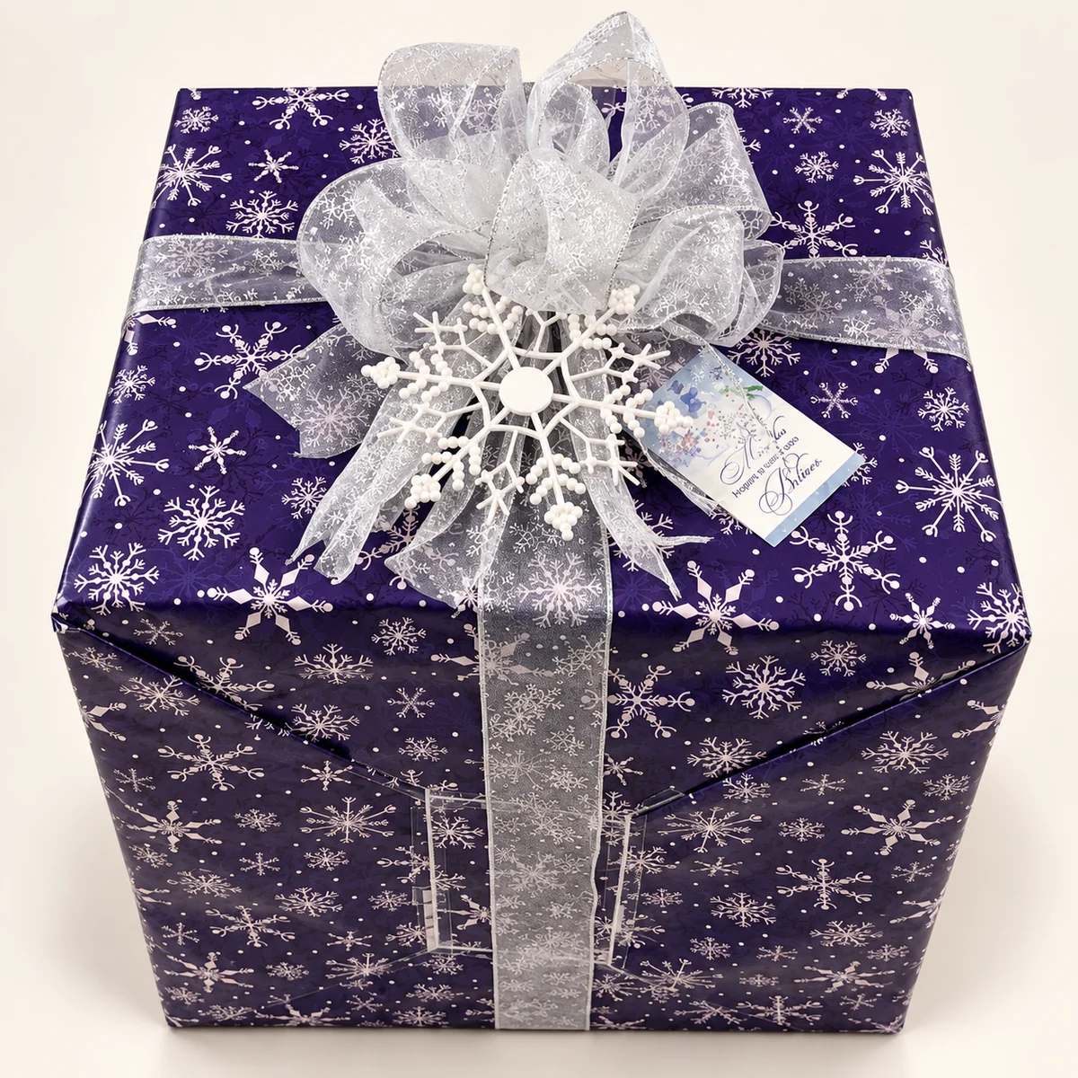 Oversized cube gift in purple snowflake paper with silver organza bow and snowflake