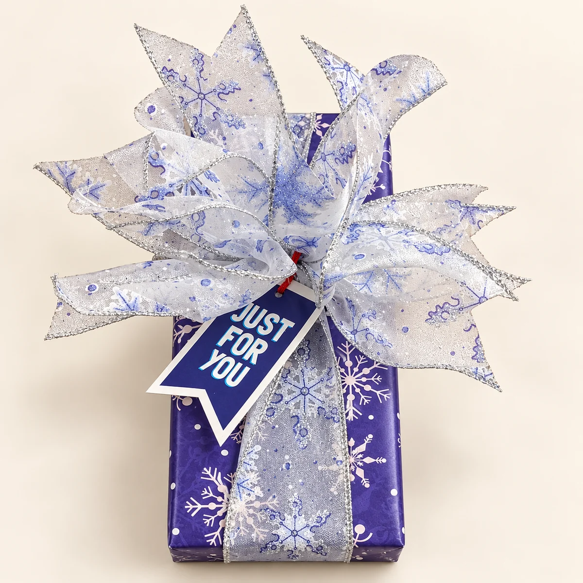 Purple snowflake gift with a silver organza bow and Just For You tag