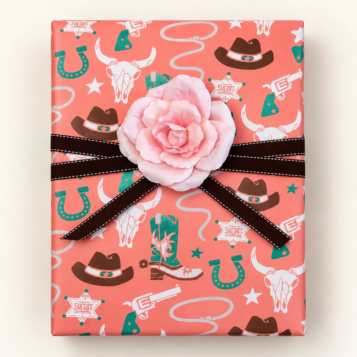 Coral western paper with brown stitched ribbon and a pink fabric rose